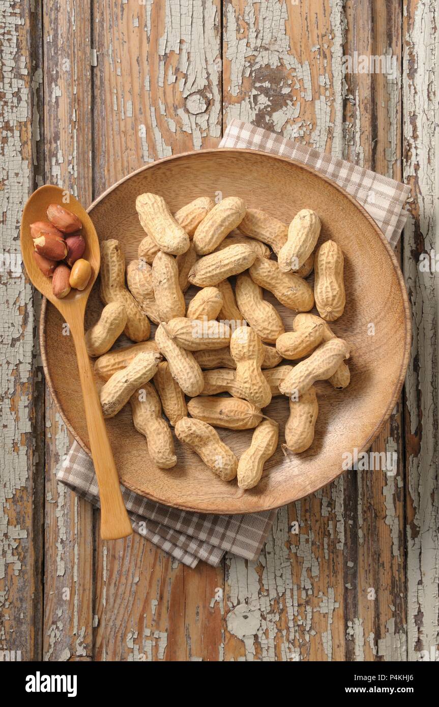 Peanuts on a wooden plate Stock Photo