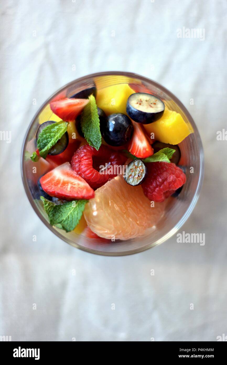 Fruit salad with a basil and mint citrus syrup Stock Photo Alamy