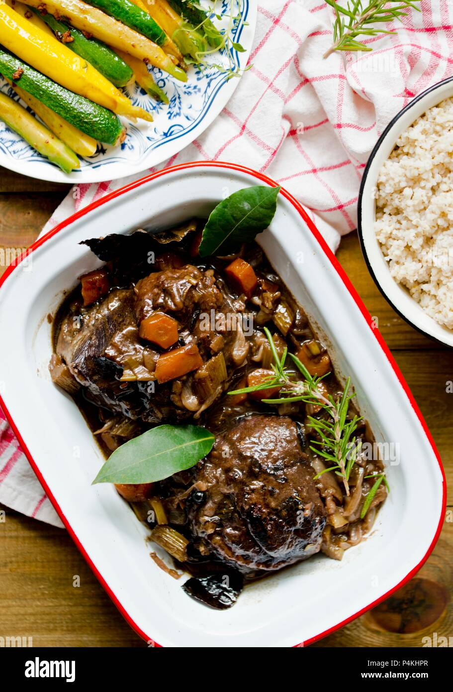 Braised beef cheeks with bay leaves and rosemary Stock Photo Alamy