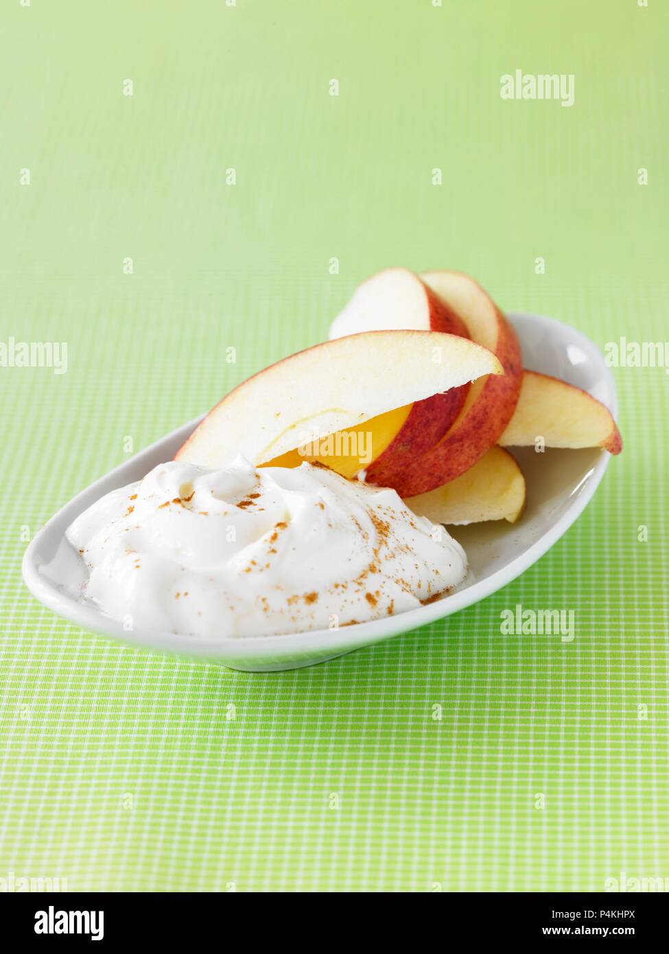 Sweet Yogurt with Apple Slices and Sprinkled Cinnamon Stock Photo