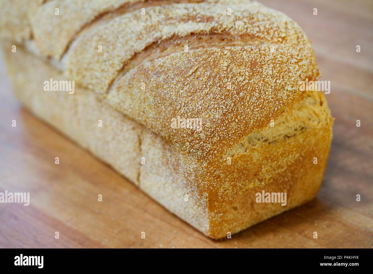 A loaf of white bread on a wooden table Stock Photo