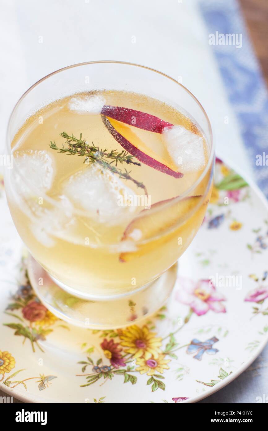 A summer cocktail with plum and thyme Stock Photo Alamy