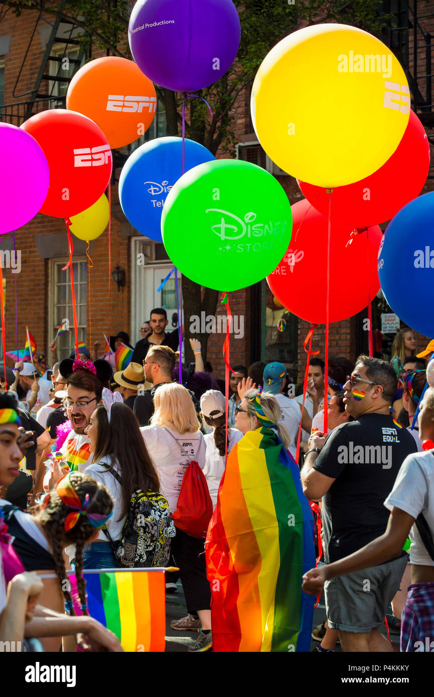 NEW YORK CITY - JUNE 25, 2017: Participants wave rainbow flags and carry colorful balloons in the annual Pride Parade in Greenwich Village Stock Photo