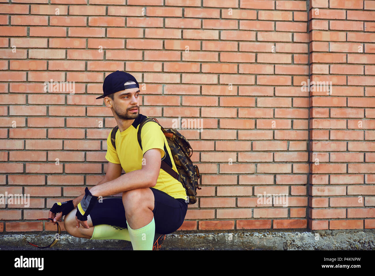 A man in sportswear with a backpack . Stock Photo