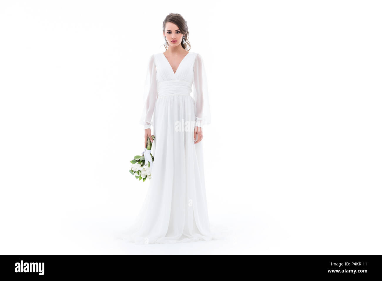 caucasian bride posing in elegant white dress with wedding bouquet ...