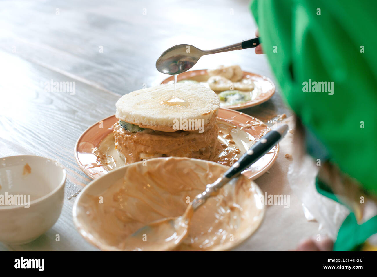Cooking class, culinary. Food and people concept, child hands in process cooking of sweet cake. Stock Photo
