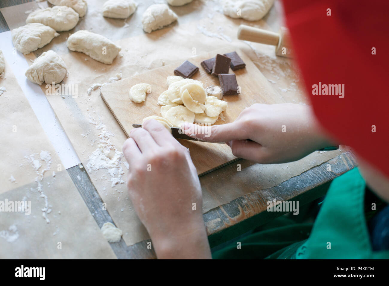 Cooking class, culinary. Food and people concept, molding of dough, child hands in process of molding, cooking of pie. Stock Photo