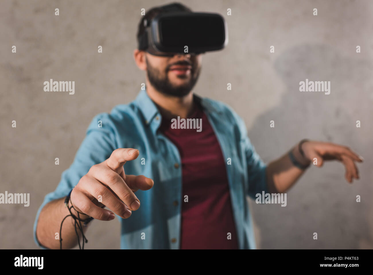 Smiling man using virtual reality headset Stock Photo