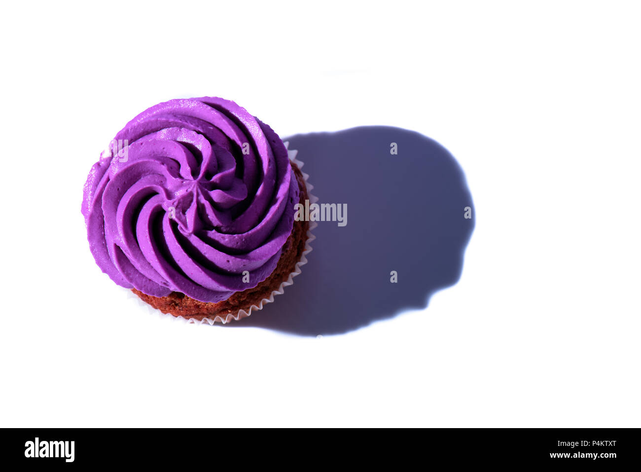 top view of cupcake with purple buttercream icing, on white surface Stock Photo Alamy