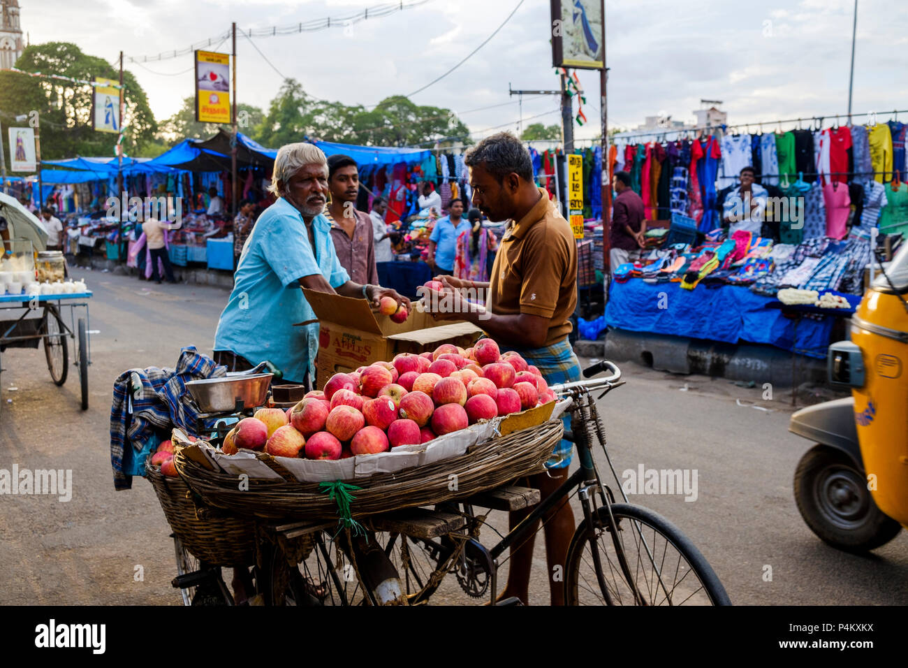 Indian men selling and buying apples at the street market on Netaji Subhas Chandra Bose Rd, Tiruchirappalli (Trichy), Tamil Nadu, India. Stock Photo