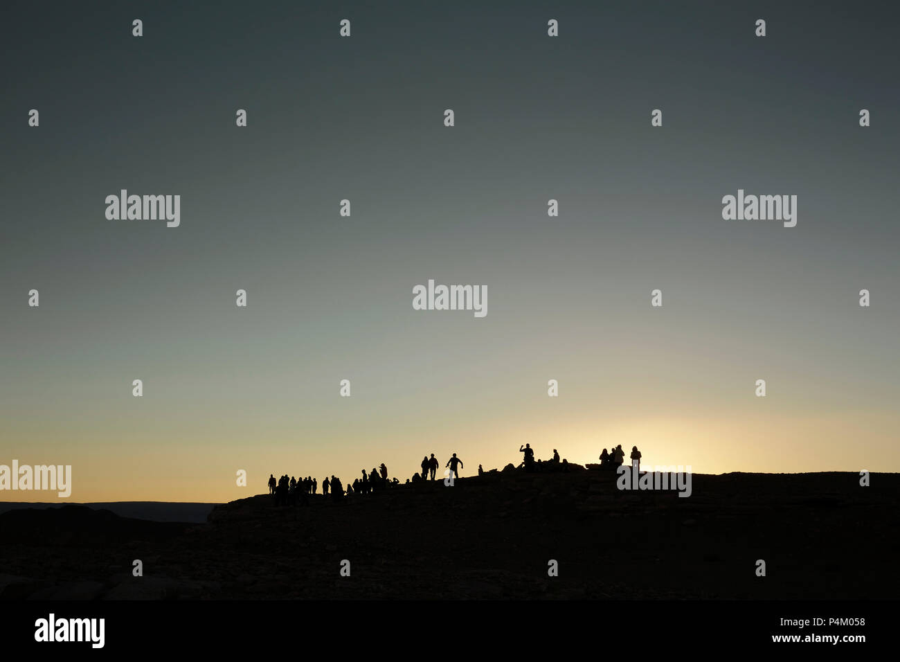 People stand on a sand dune Stock Photo - Alamy