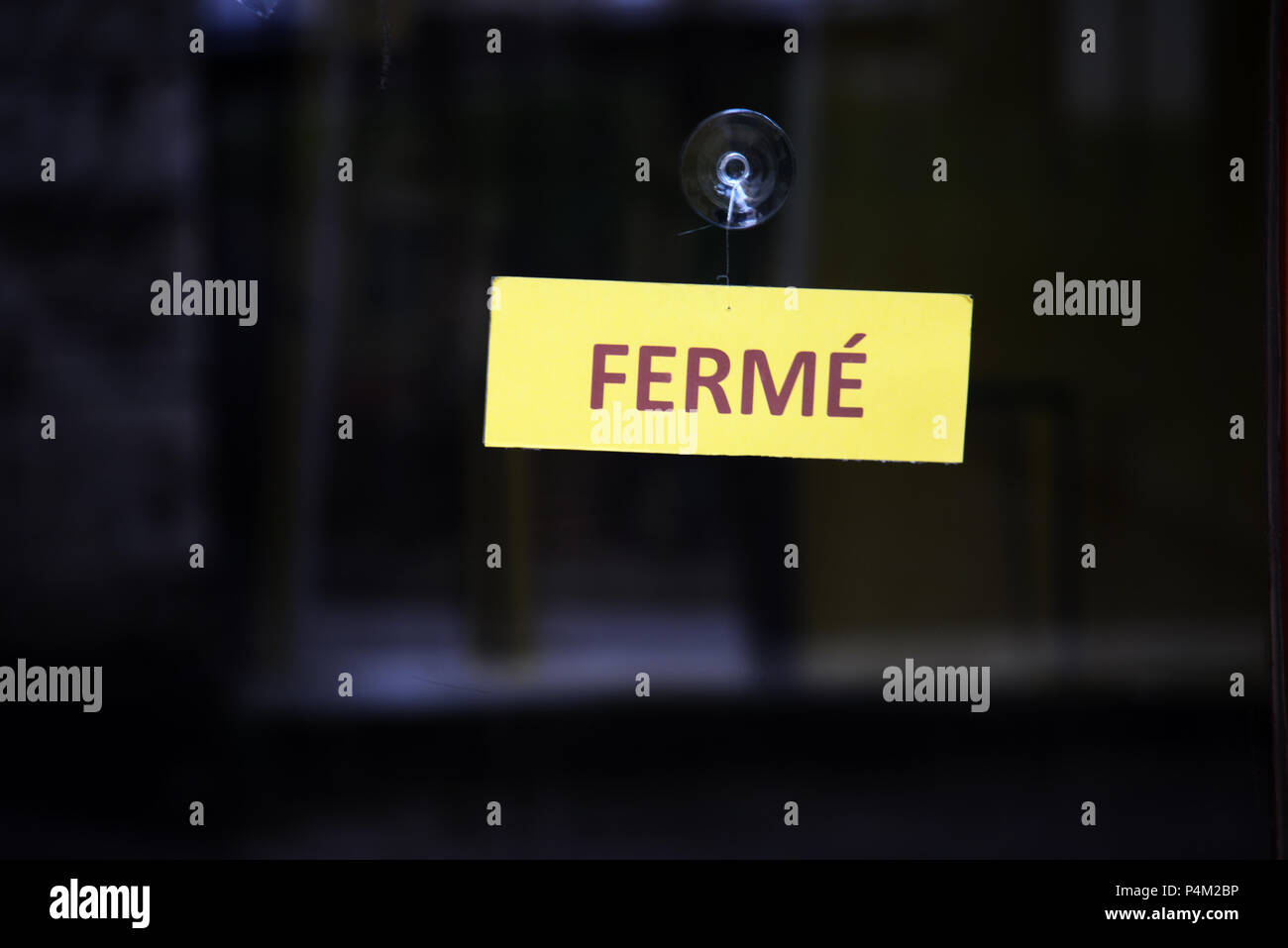 window night image of French shop closed sign with copy space ferme ...