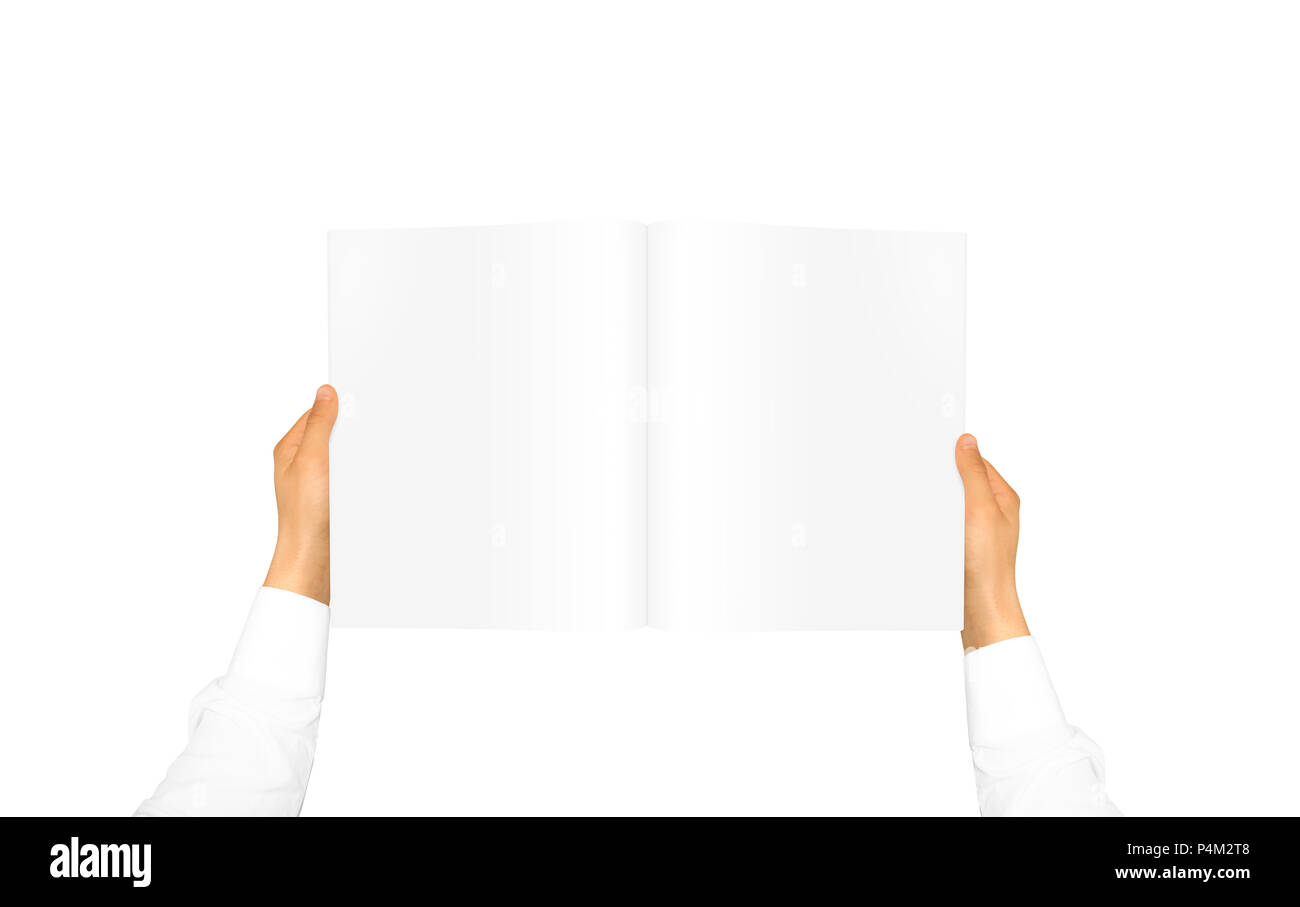 Hand in white shirt sleeve holding blank journal in the hand. Empty magazine presentation. Pamphlet hand man. Man show pages. Sheet template. Booklet  Stock Photo