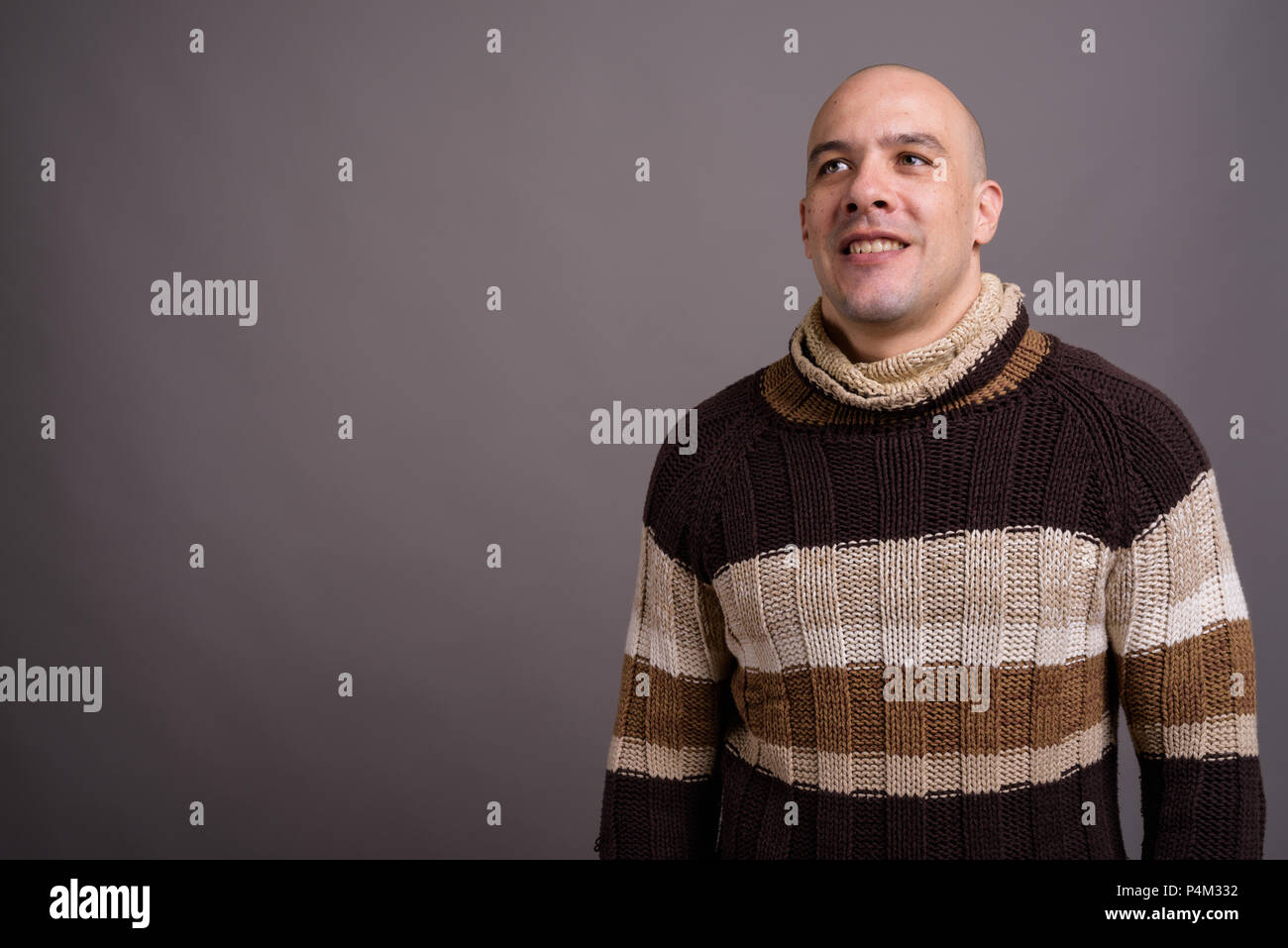 Handsome bald man against gray background Stock Photo