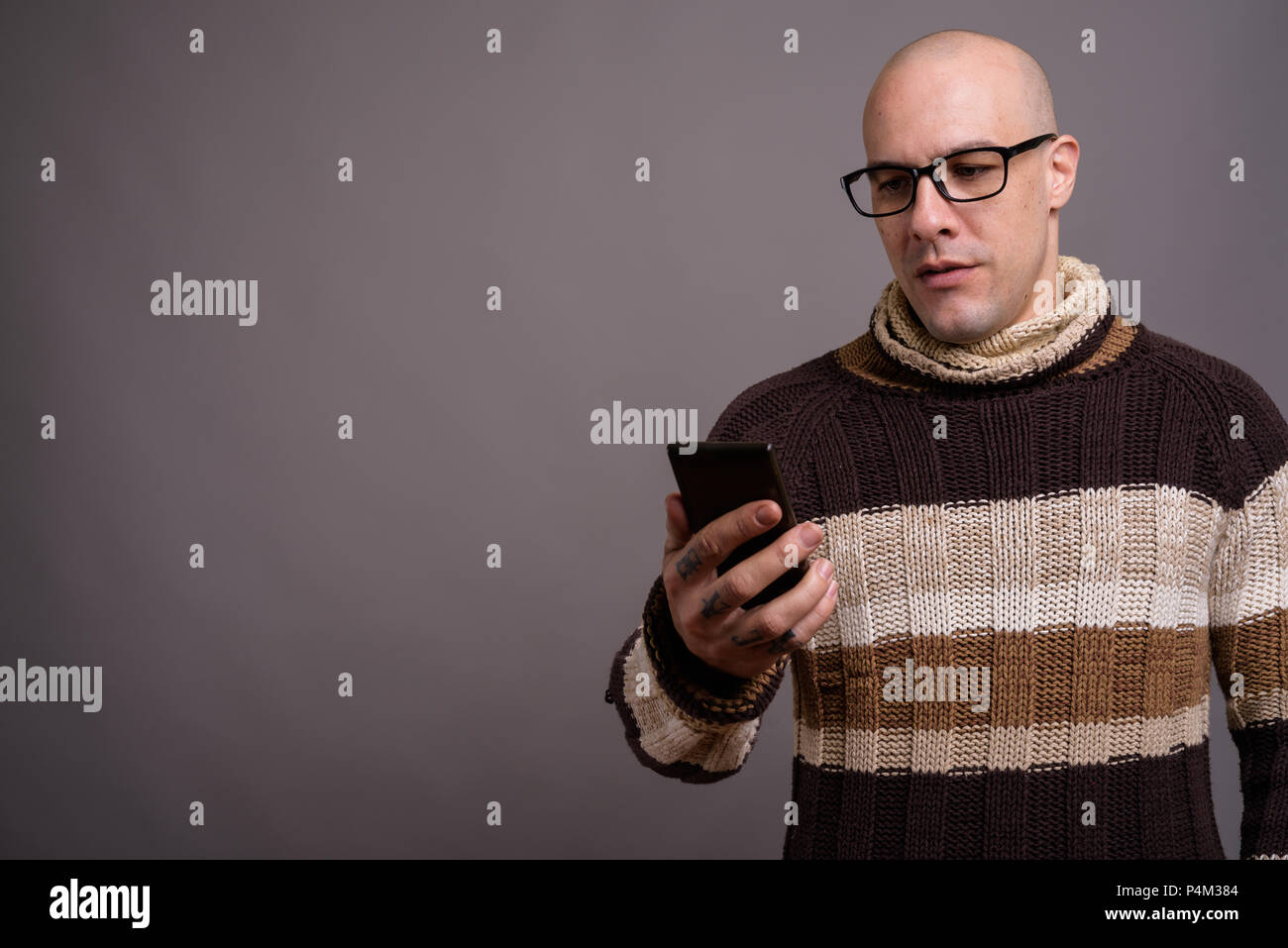 Handsome bald man against gray background Stock Photo