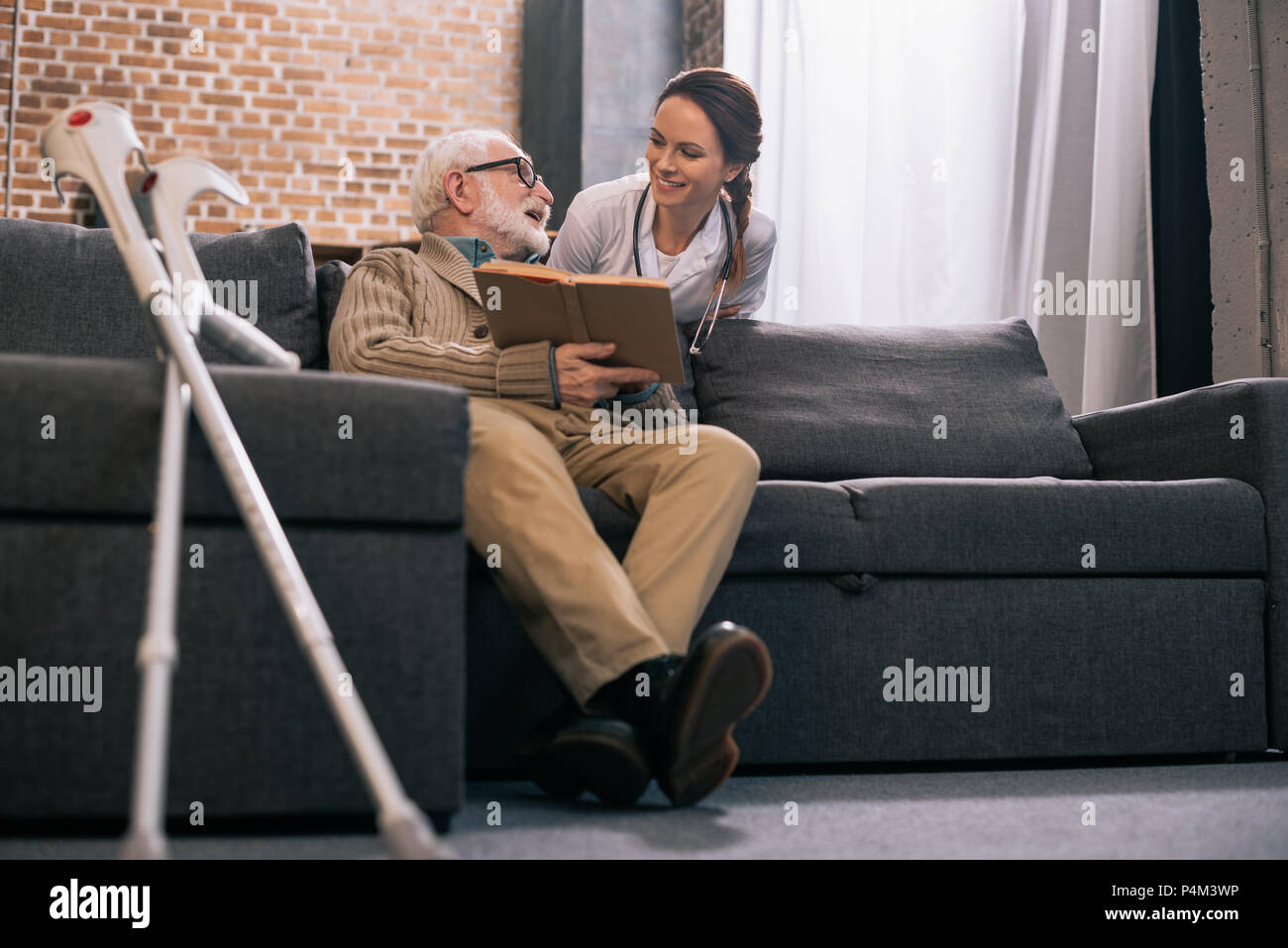 Doctor talking elderly woman crutches hi-res stock photography and ...