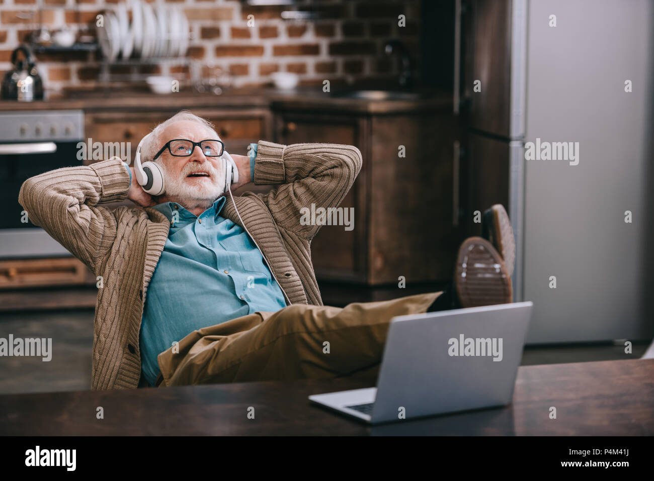 Happy male patient using laptop hi-res stock photography and images - Alamy