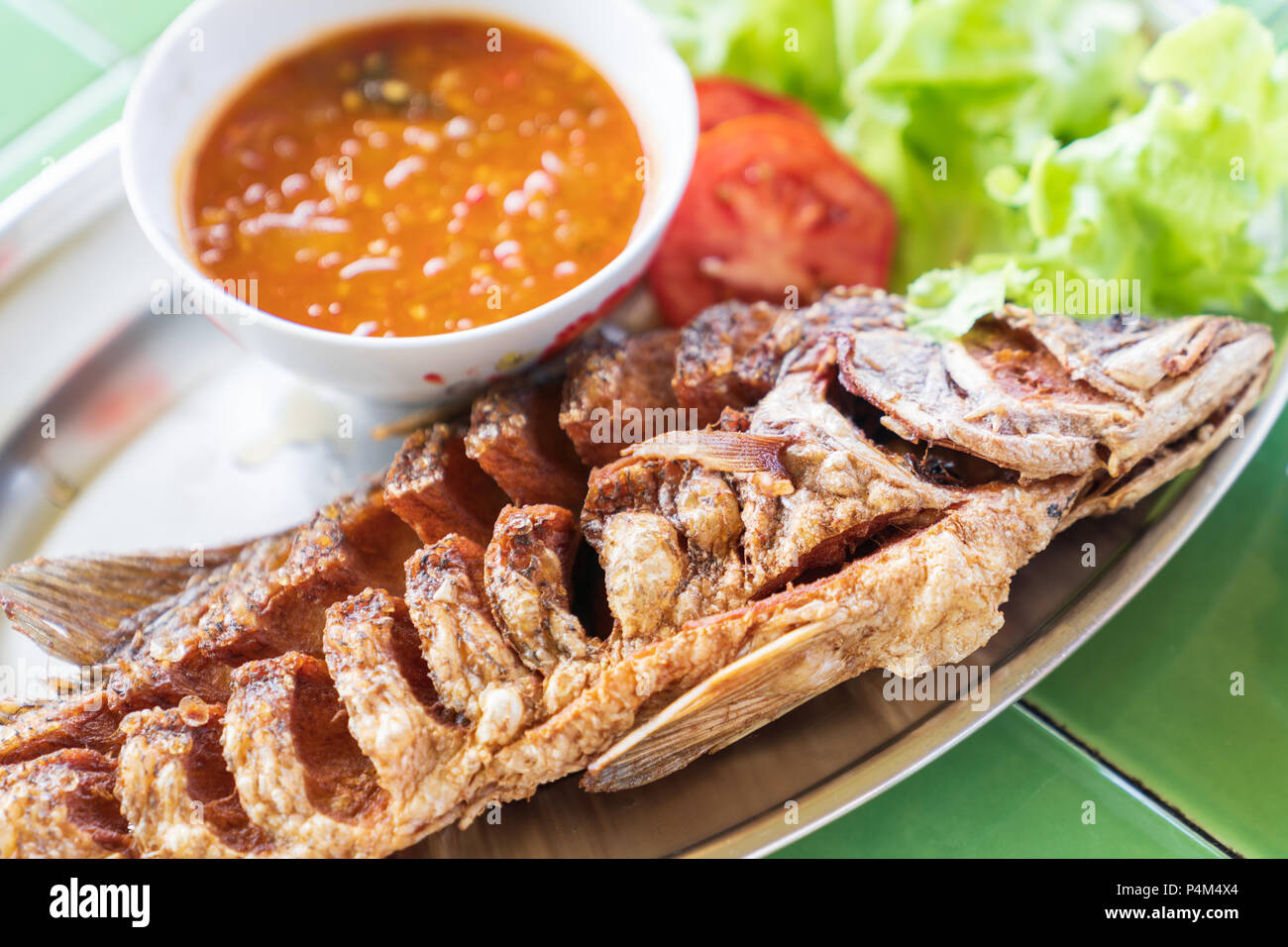 Fried fresh big fish with salad and hot spicy sauce, thai food style ...