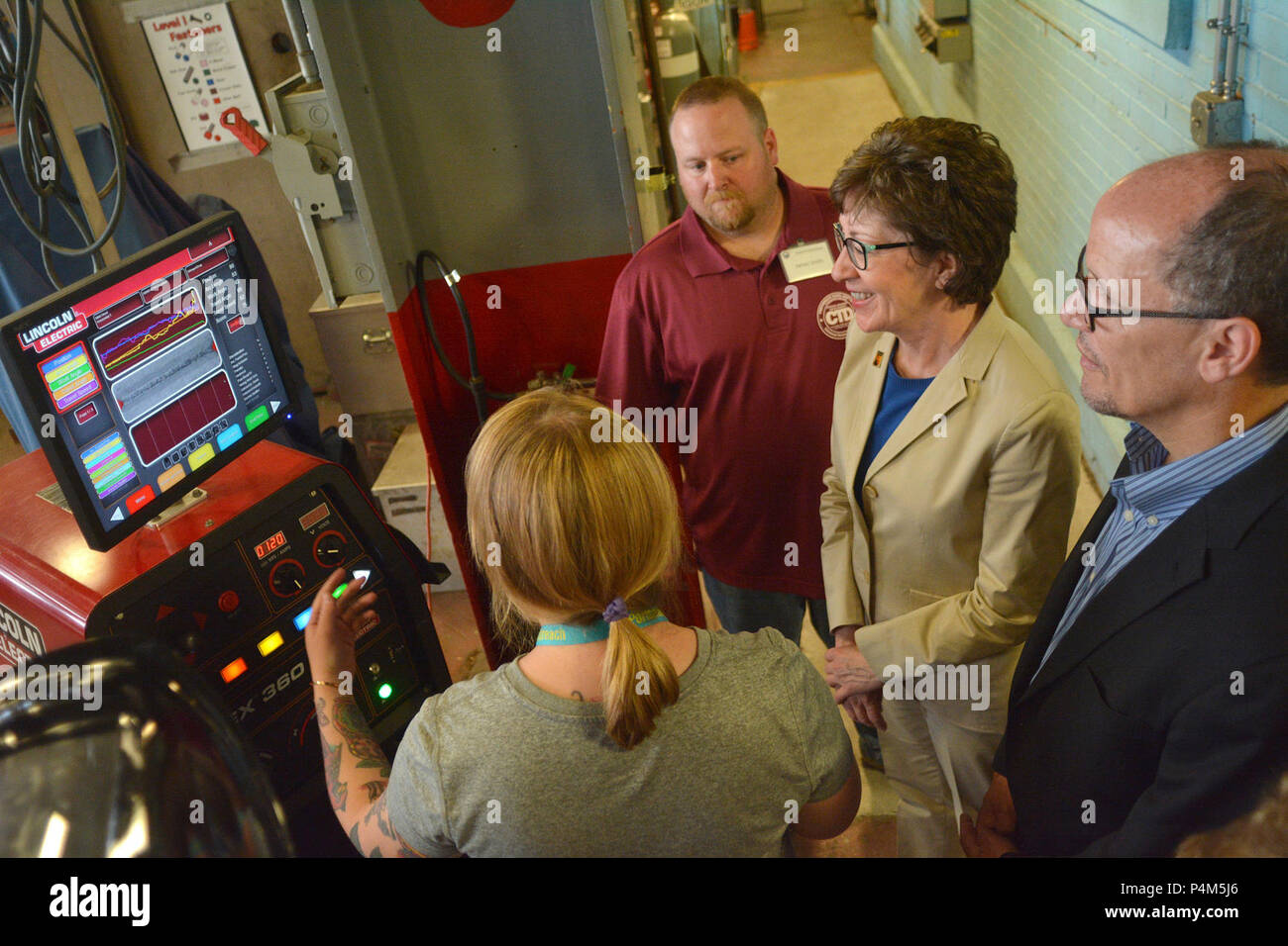 KITTERY, Maine -- 5/27/15 -- Portsmouth Naval Shipyard (PNS) employee Jen Ouellette, left, explains the operation of a virtual welding trainer system to U.S. Senator Susan Collins (R-Maine) and U.S. Secretary of Labor Thomas Perez at PNS in Kittery on Wednesday.  The delegation visited Bath Iron Works in Bath and Portsmouth Naval Shipyard in Kittery to promote private and public partnerships supporting apprenticeships in the maritime industry. Stock Photo