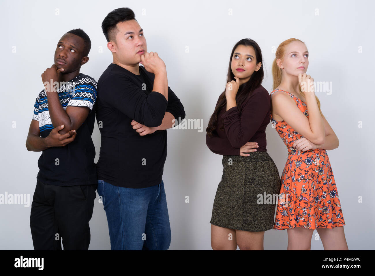 Studio shot of diverse group of multi ethnic friends thinking wh Stock Photo
