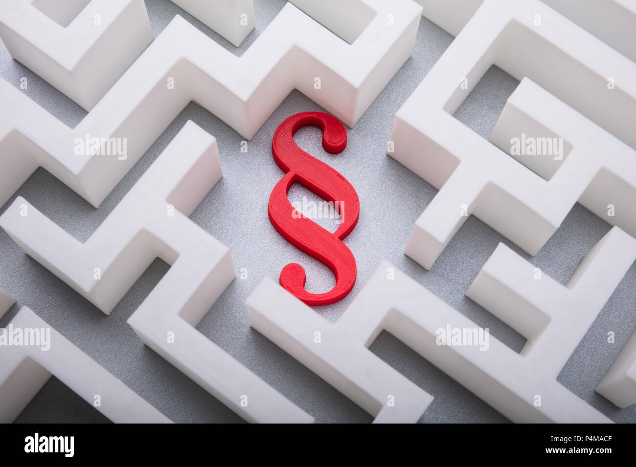 Elevated View Of Red Paragraph Symbol In The Centre Of White Maze Stock Photo