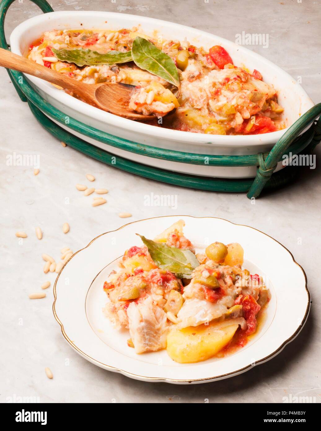 Salt cod alla messinese with potatoes, tomatoes and olives (Sicily