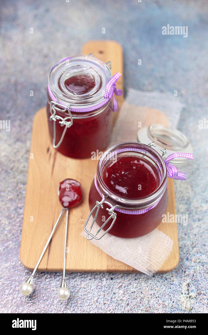 Red fruit jam in two glass jars Stock Photo Alamy