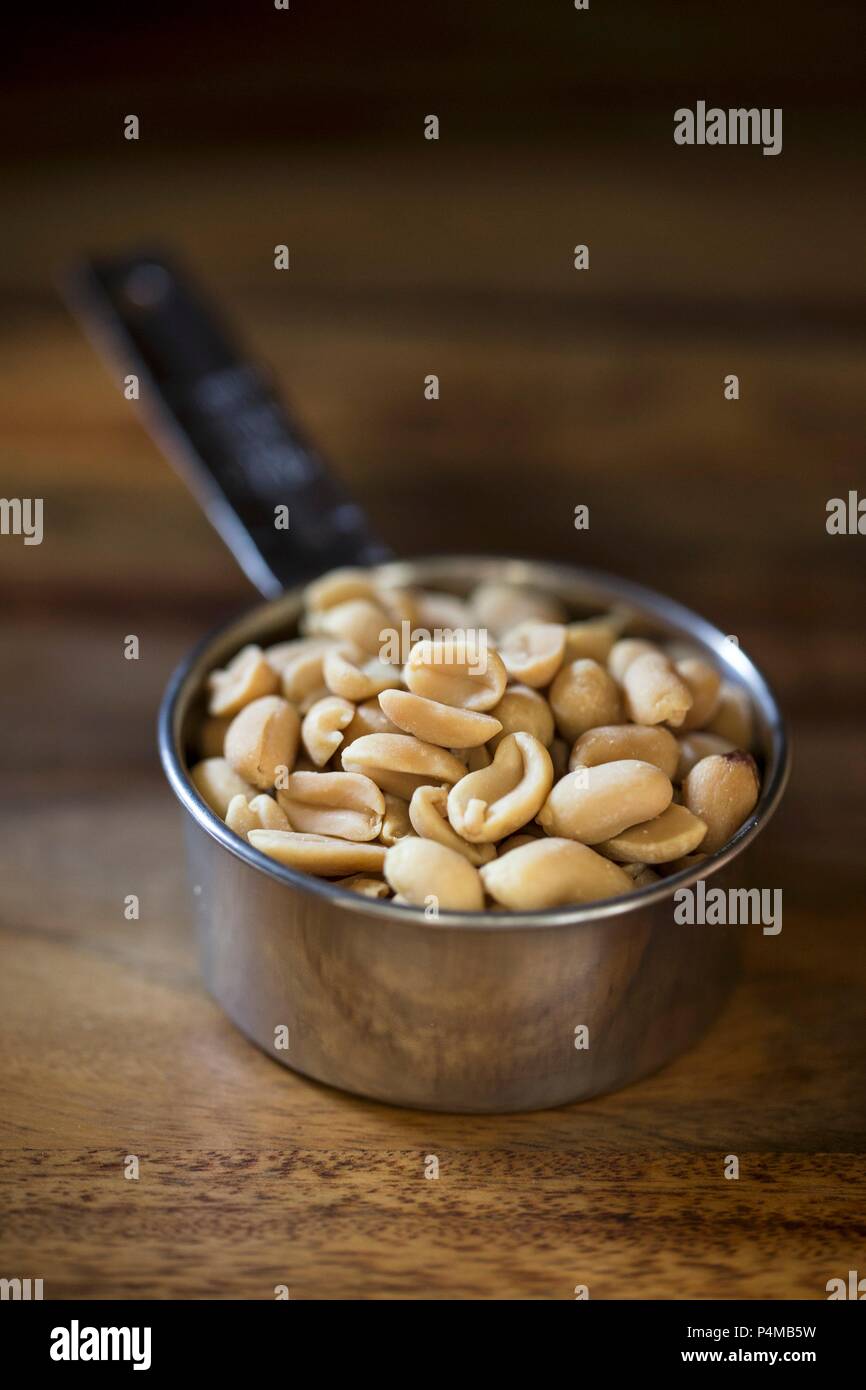 Peanuts in a measuring cup Stock Photo