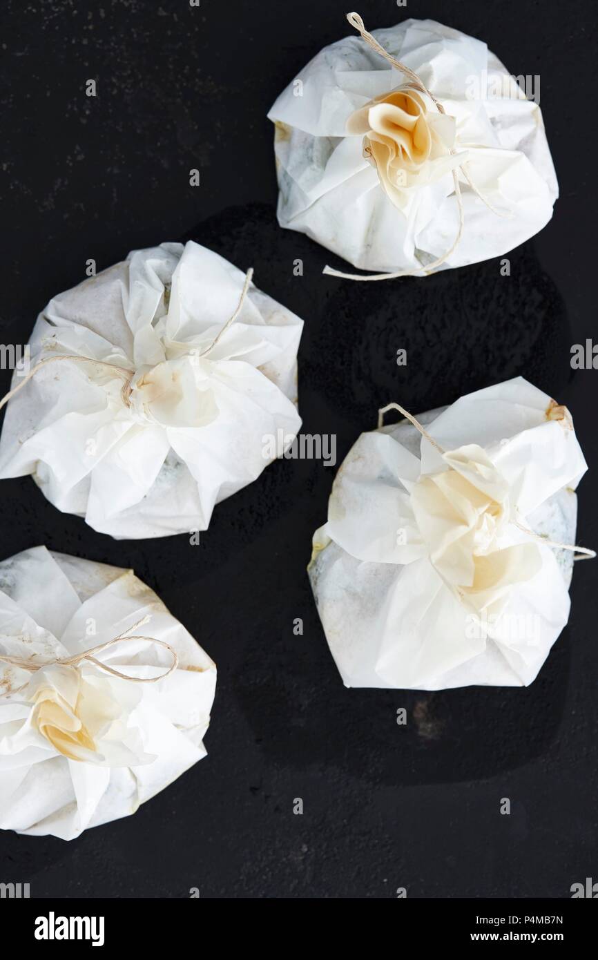Tied parchment paper packets Stock Photo