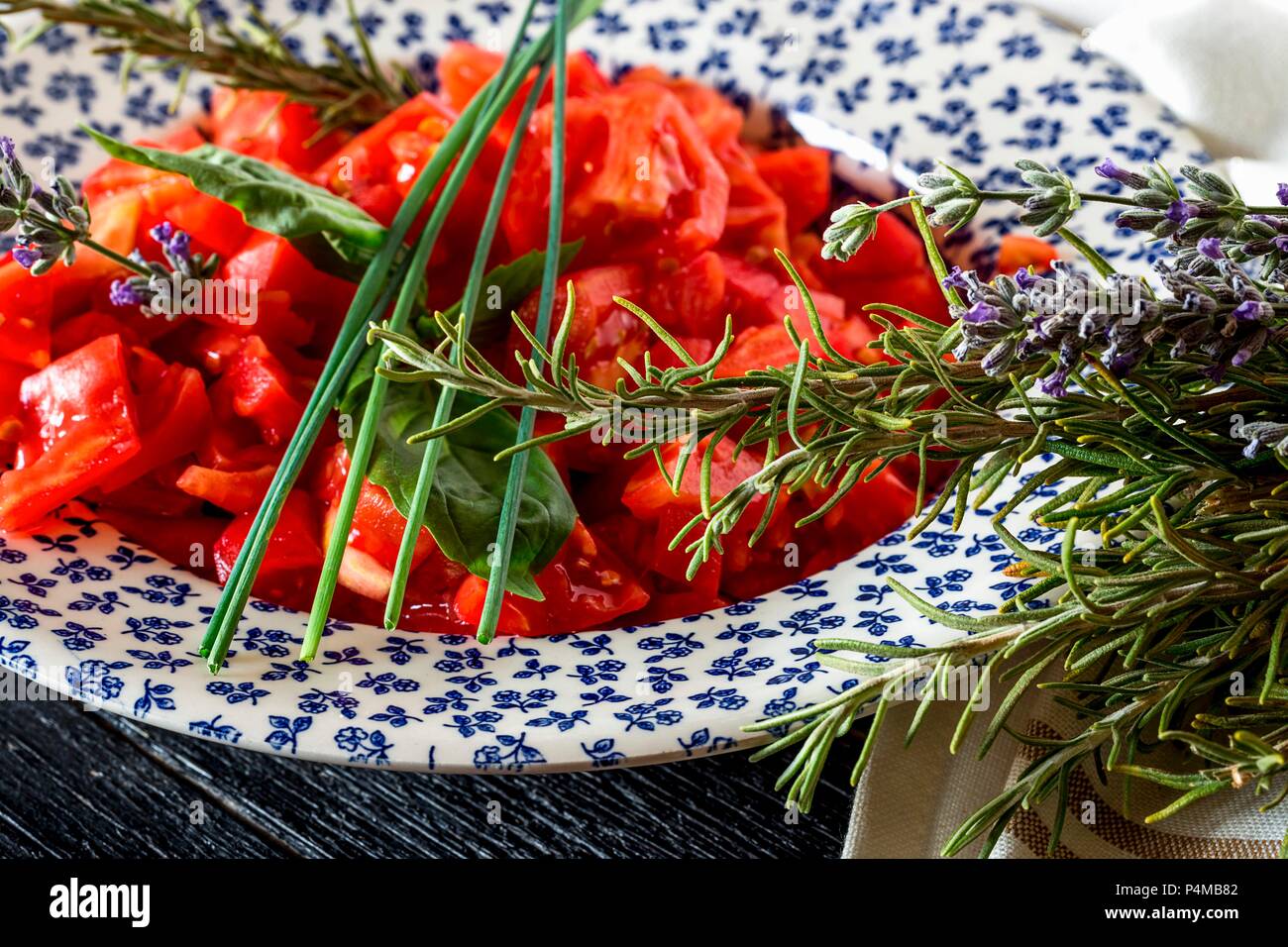 Tomato salad with basil and rosemary Stock Photo