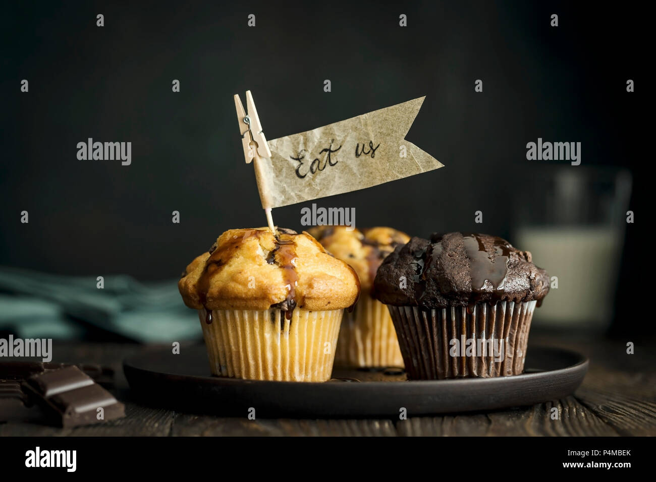 Vanilla and chocolate muffins with chocolate chunks and paper flags Stock Photo