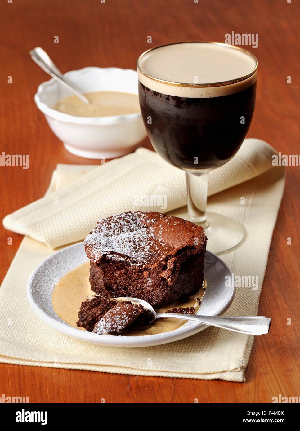 Chocolate cake with vanilla sauce and Irish coffee Stock Photo