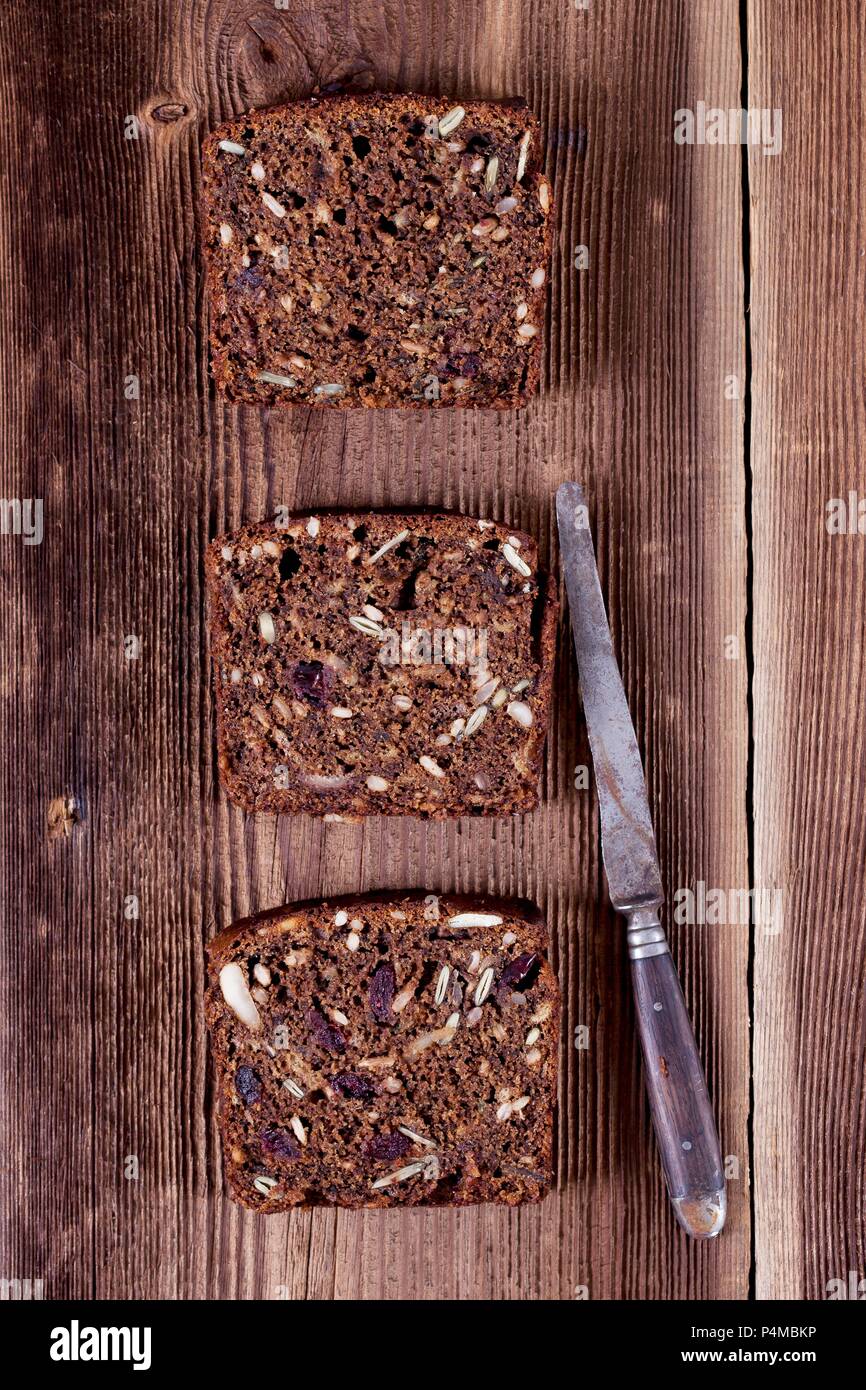 Three slices of banana bread with sunflower seeds, pumpkin seeds, cranberries, apple butter and walnut flour Stock Photo