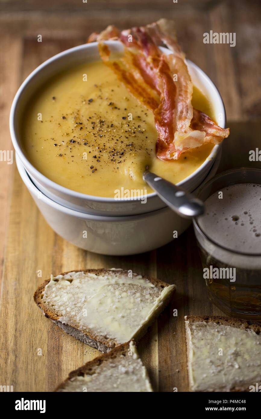 Potato soup with beef sausage and buttered bread Stock Photo