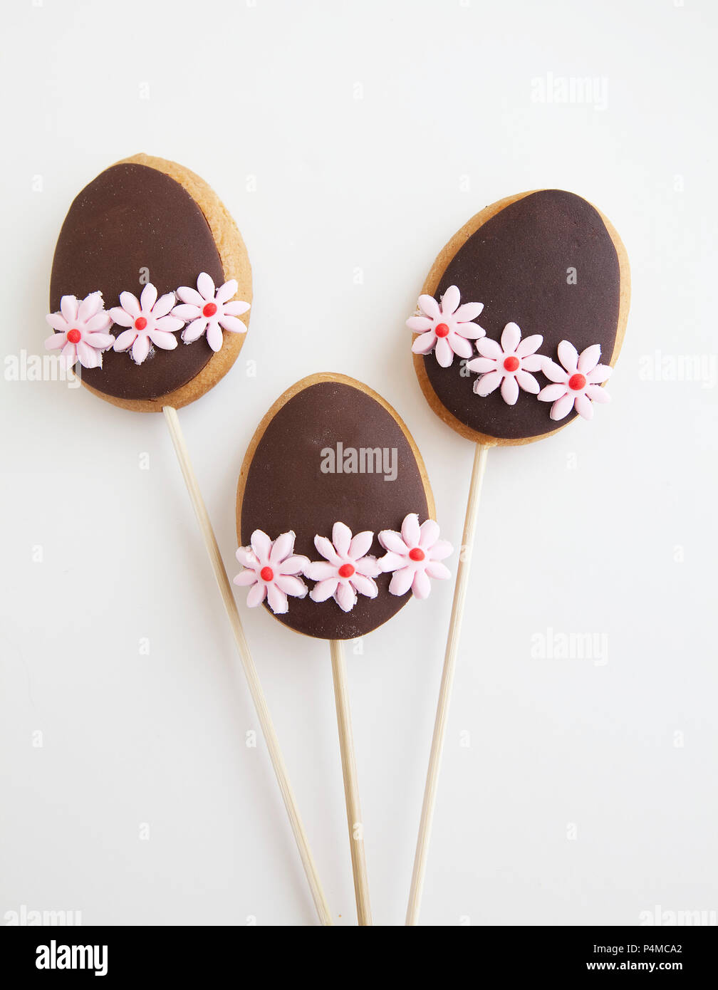 Three Decorated Easter Egg shaped cookies on a stick Stock Photo
