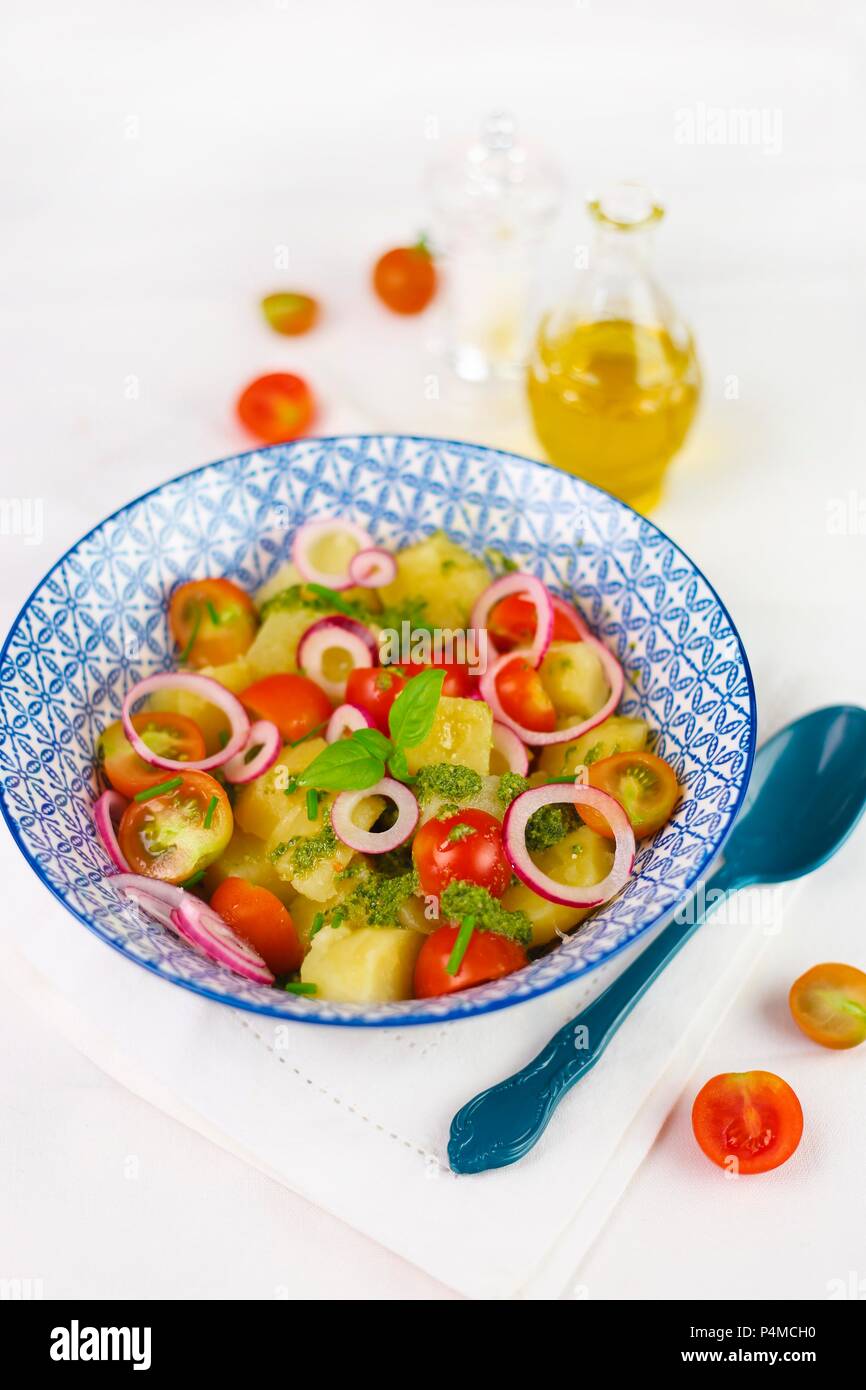 Potato salad with cherry tomatoes, tropea onions and pesto Stock Photo