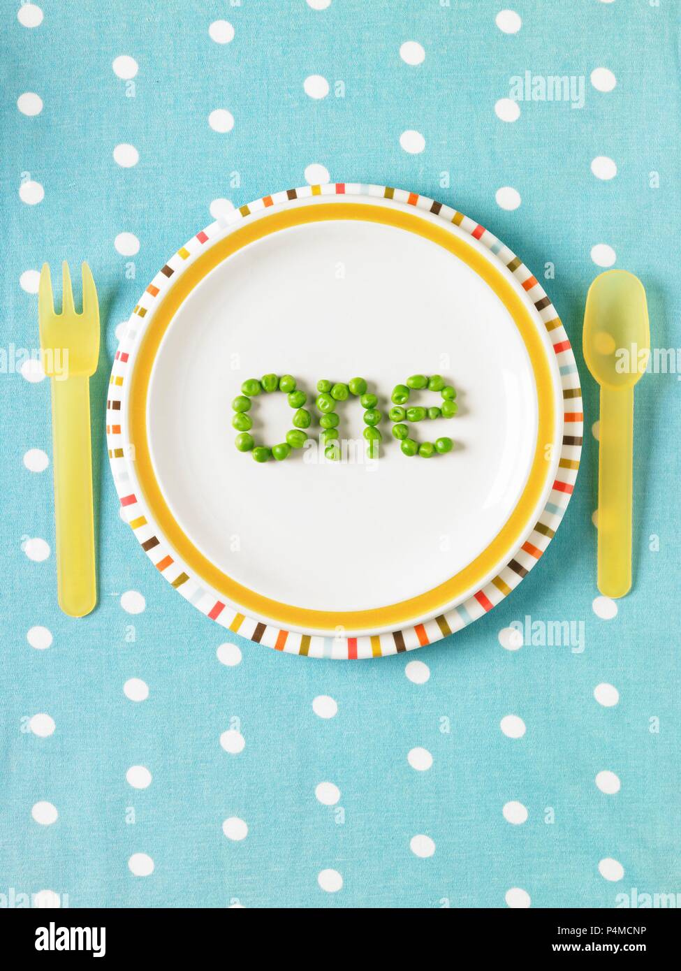The word 'one' spelled out with peas on a plate Stock Photo