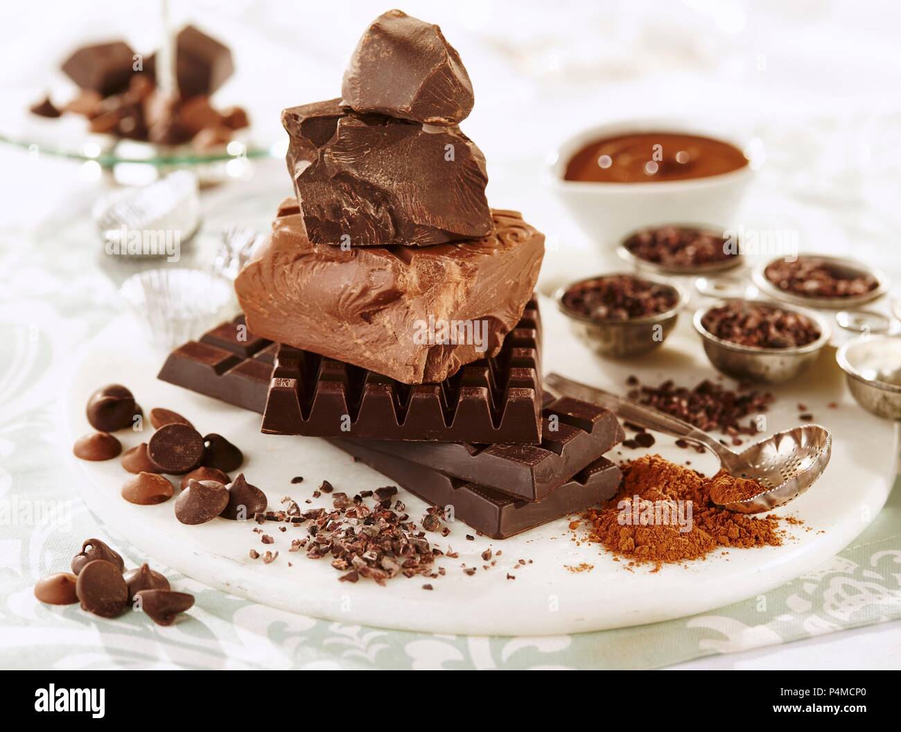 Assorted chunks of chocolate, chocolate chips, cocoa powder and cocoa nibs Stock Photo Alamy