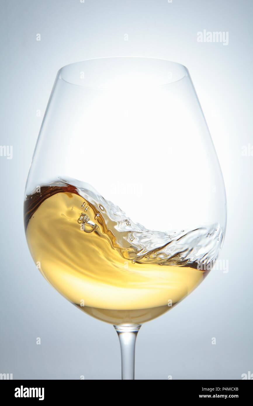 White wine in a glass with a wave Stock Photo