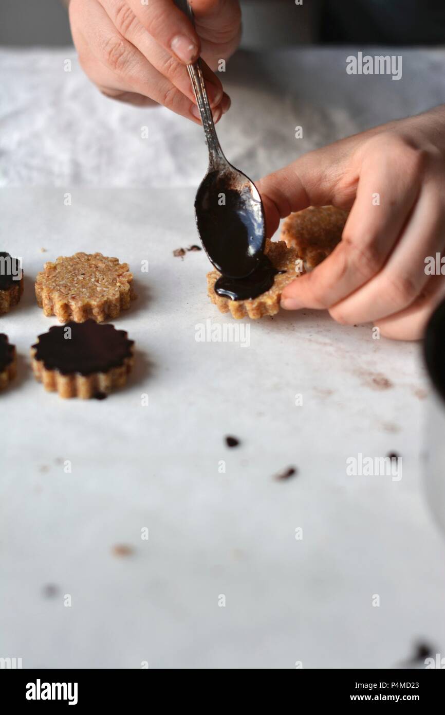 Raw vegan oat cookies with a chocolate glaze Stock Photo