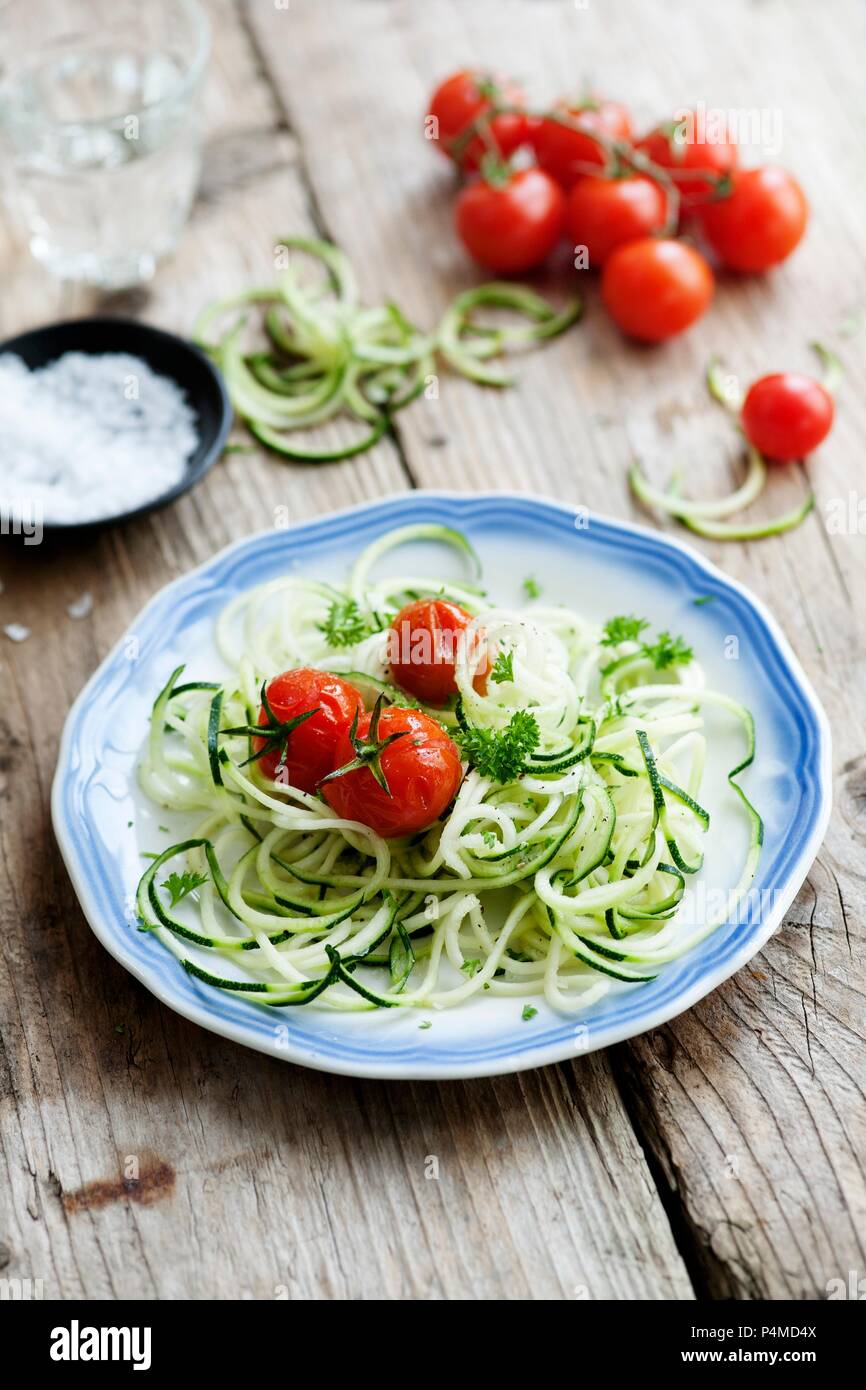 Spiralized courgettes with roasted vine tomatoes Stock Photo