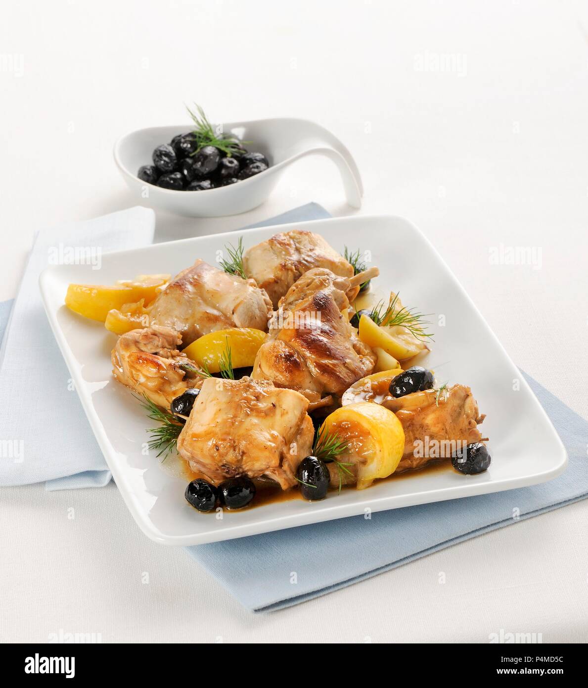 Saddle of rabbit in a lemon marinade with olives Stock Photo