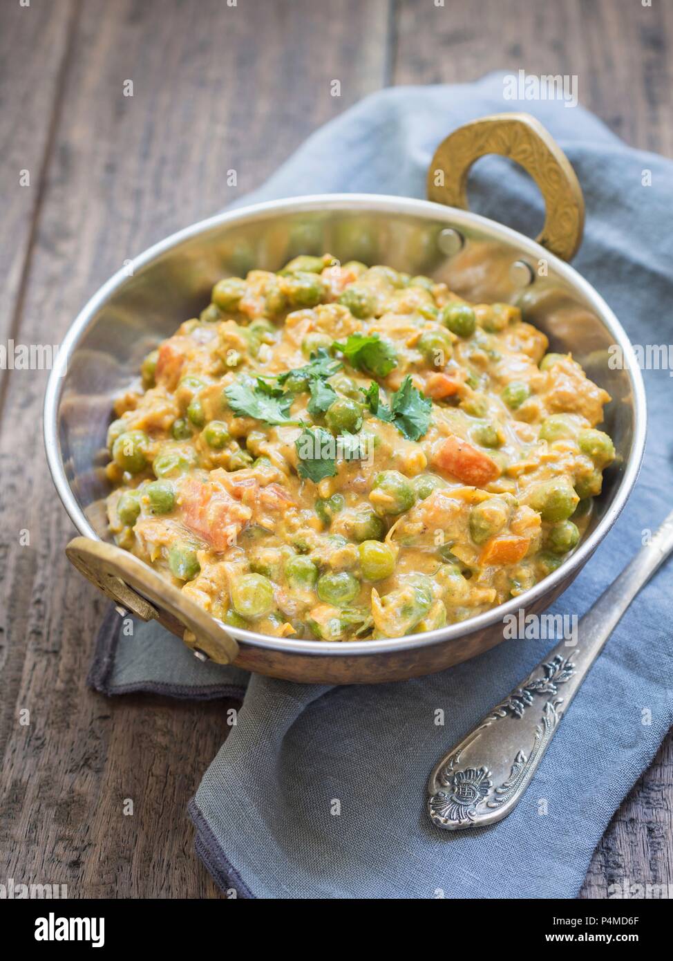 Green pea curry masala in a copper pot (India Stock Photo Alamy