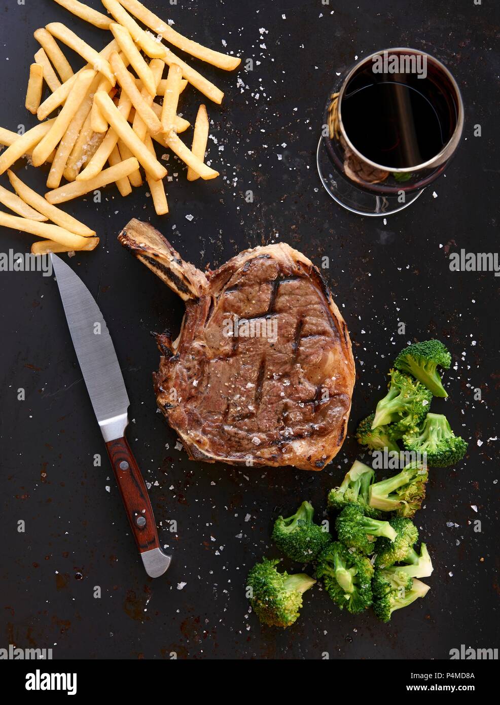 Prime rib steak with fries and broccoli Stock Photo - Alamy