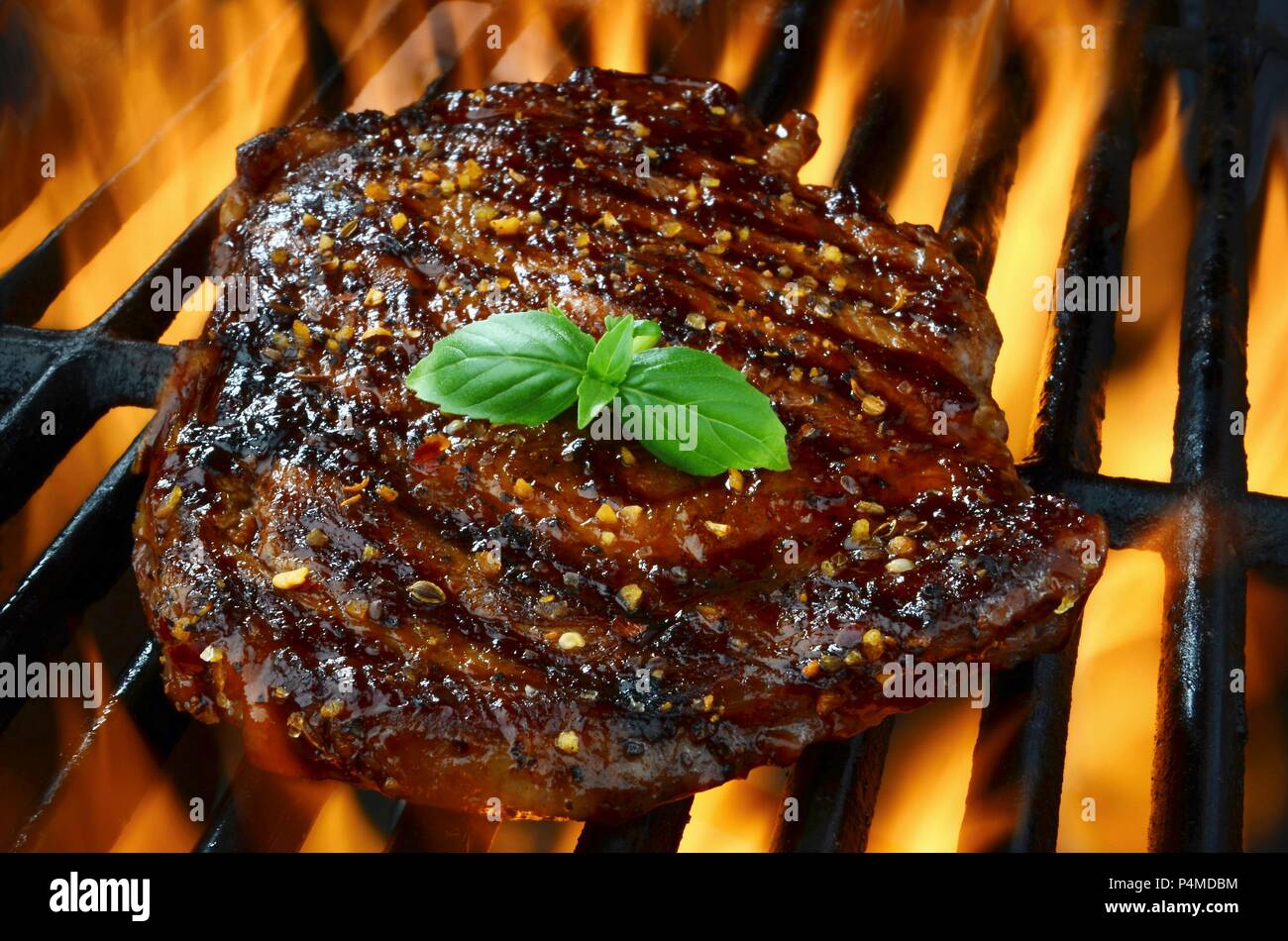 Rib eye steak on a flaming grill Stock Photo Alamy