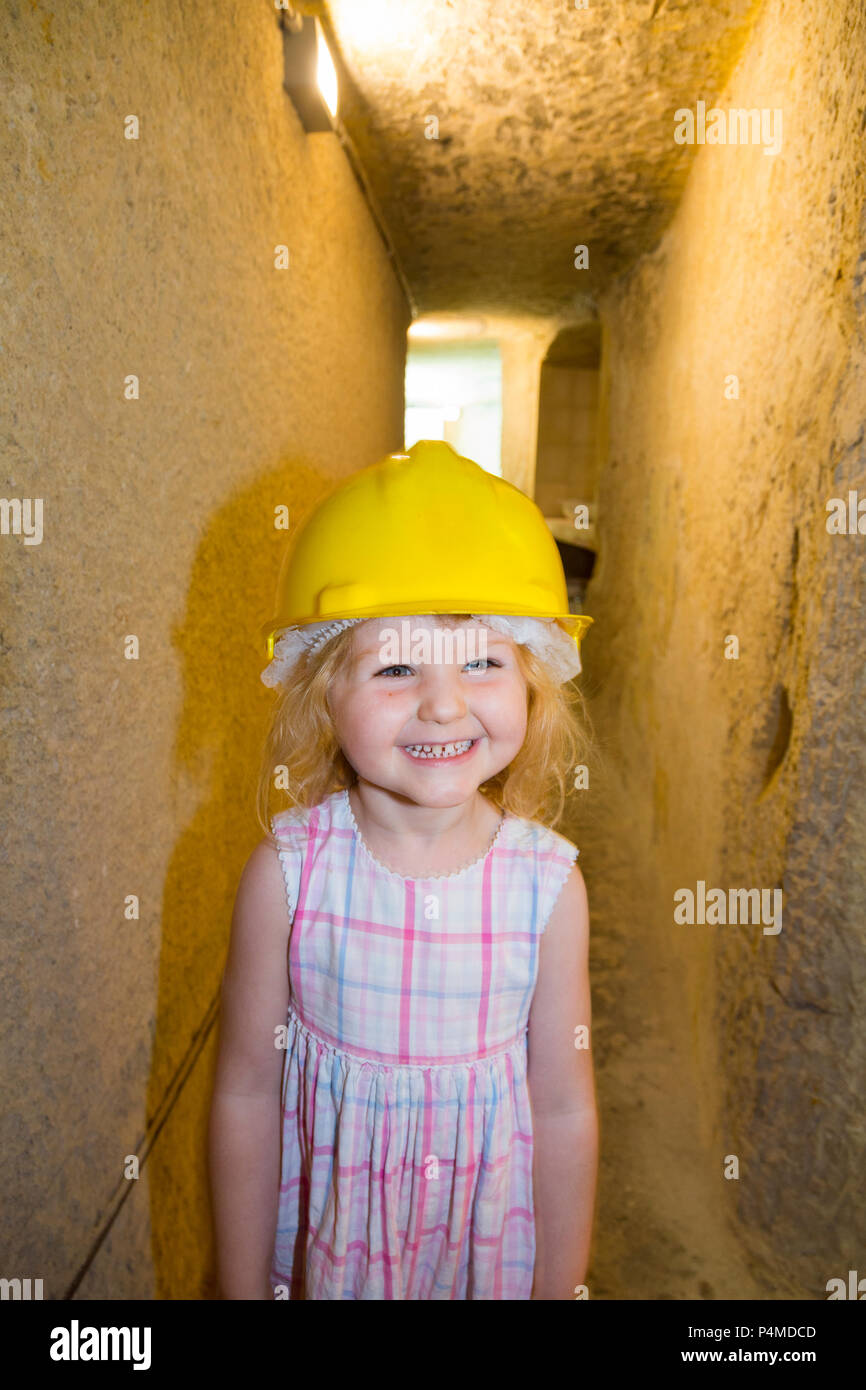 Child / children / kid / kids / family enjoy exploring the air raid shelter tunnel / tunnels inside / underground at the Malta At War Museum, Malta. Stock Photo