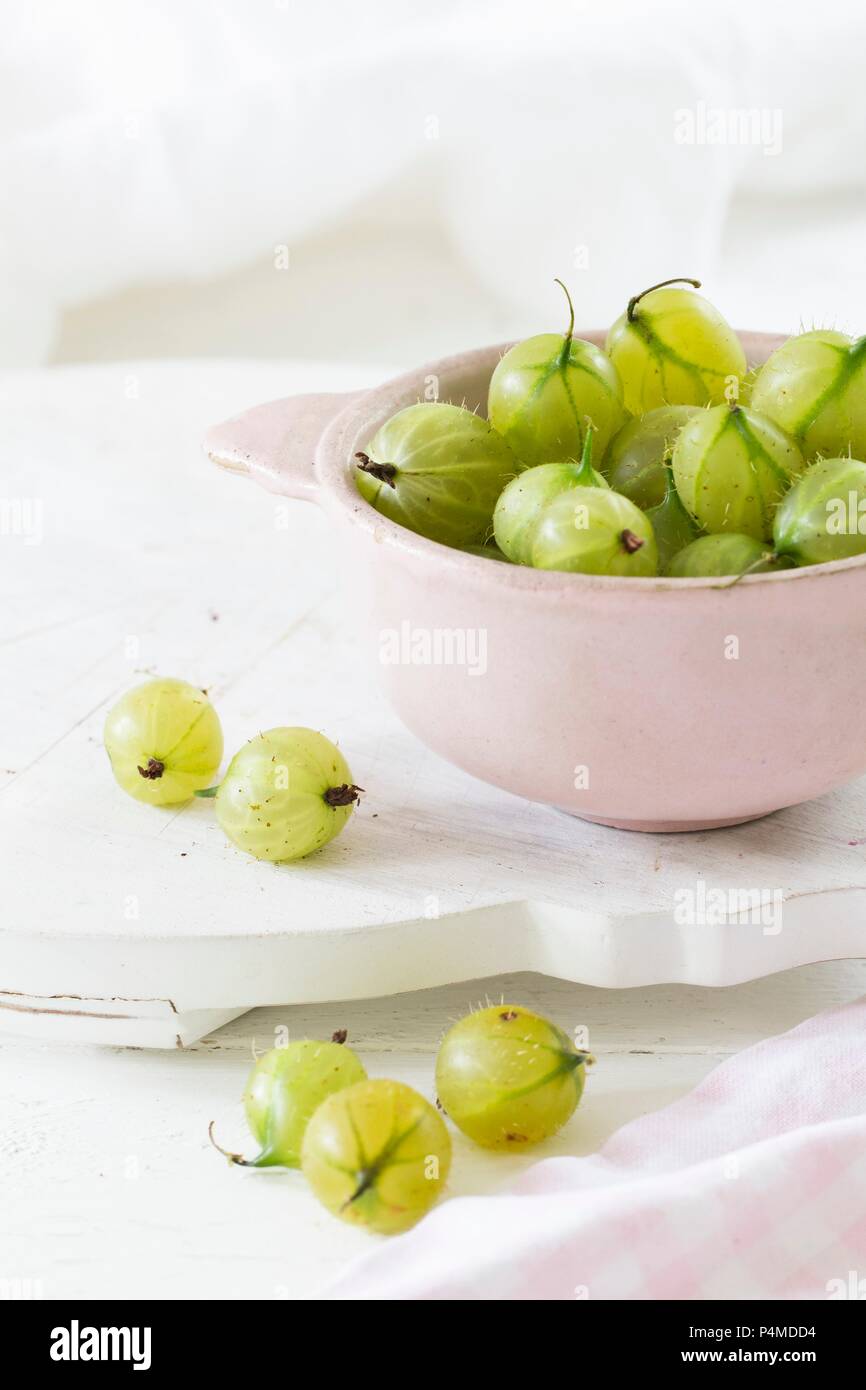 Green gooseberries in a bowl Stock Photo