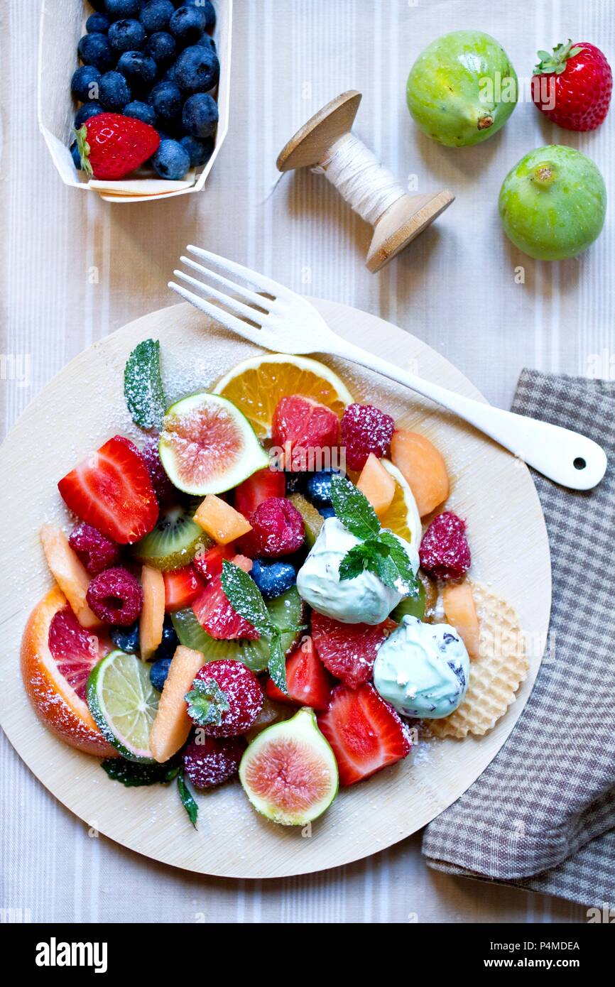 A large fruit salad with mint ice cream Stock Photo