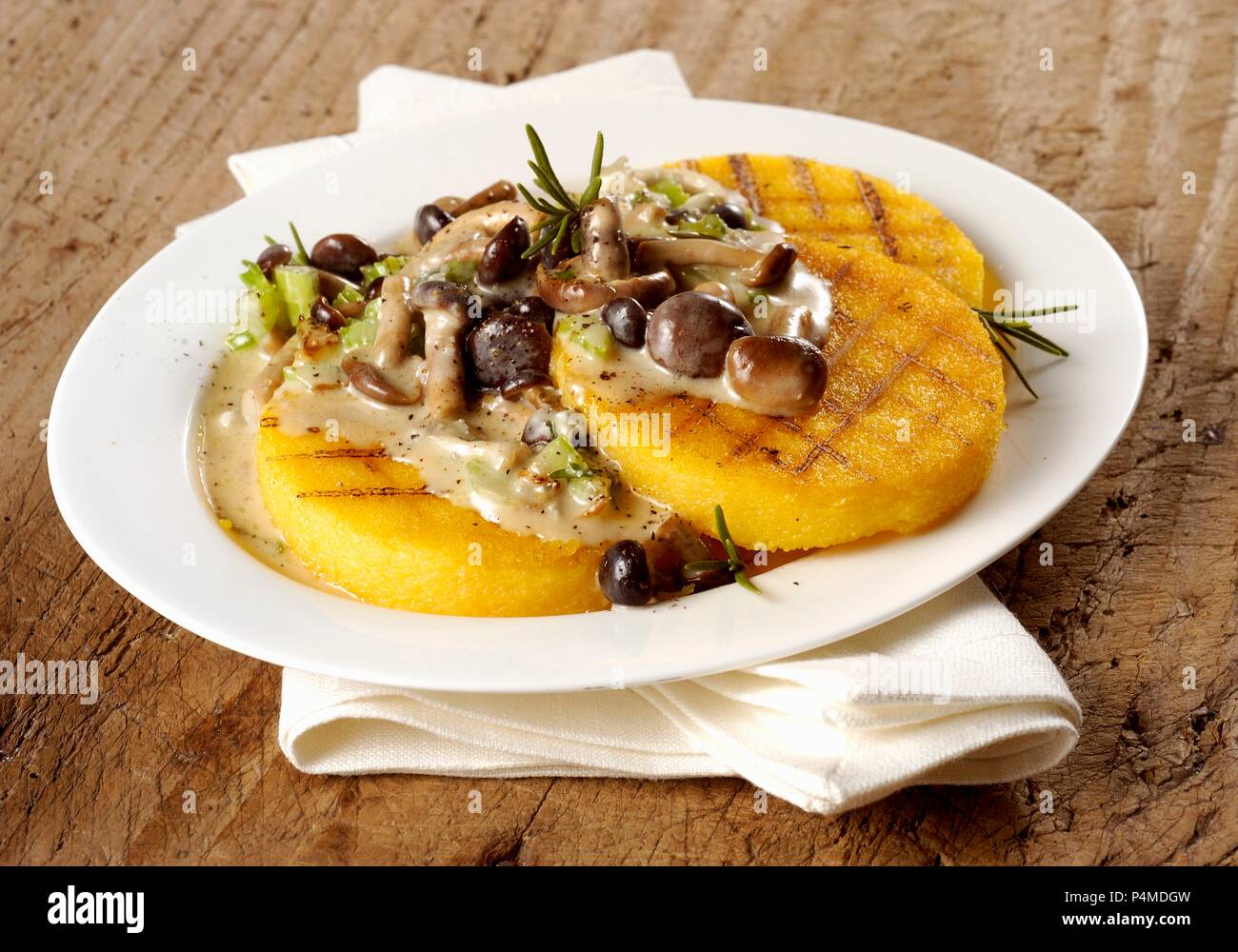 Grilled polenta with mushrooms and rosemary Stock Photo