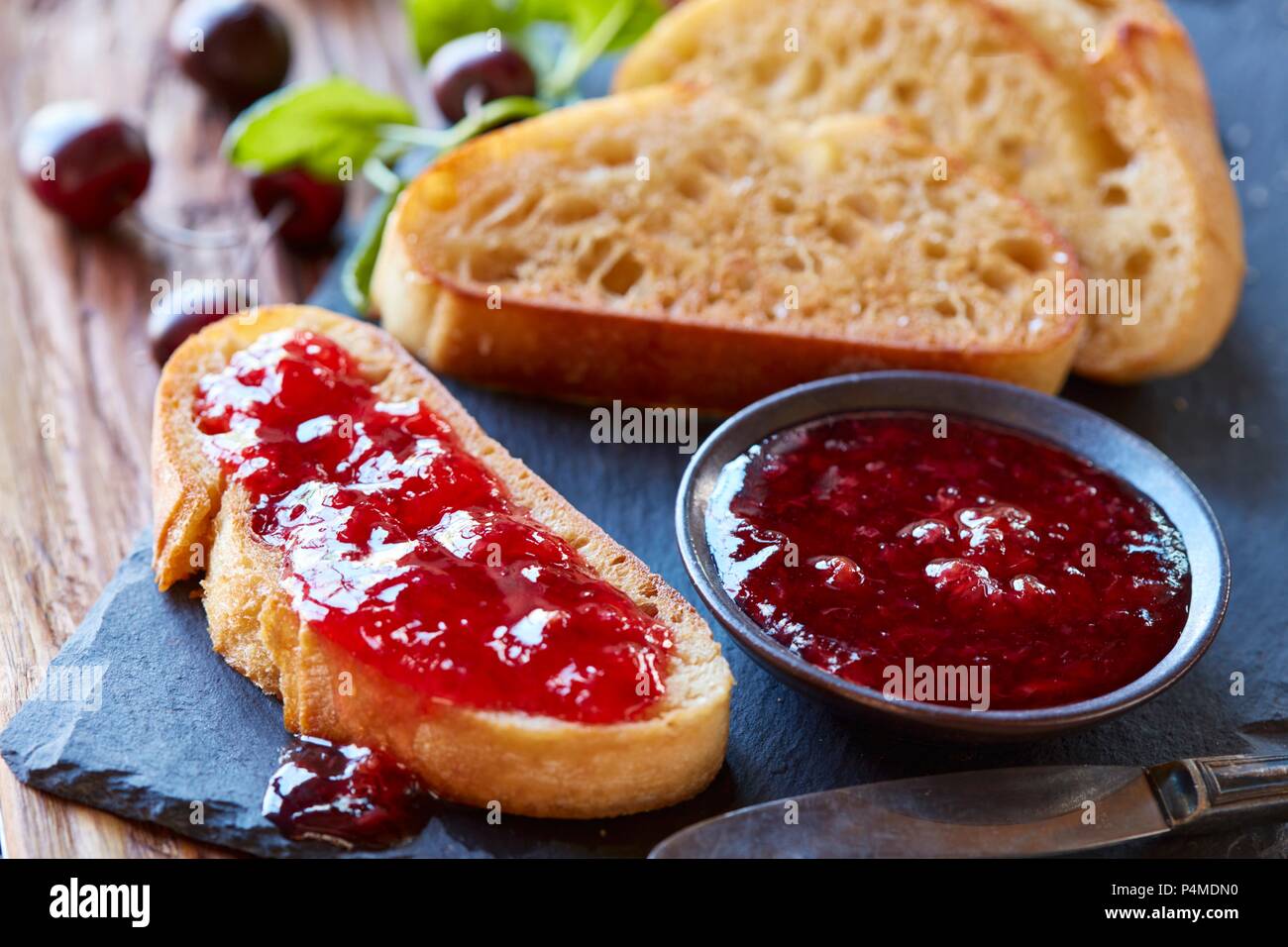 Cherry jam with toasted bread Stock Photo